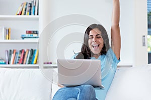 Cheering indian woman in quarantine at computer photo