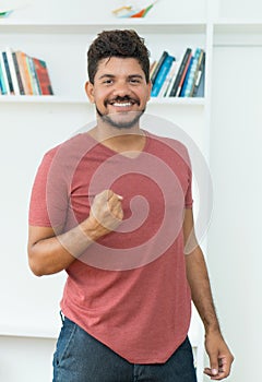 Cheering latin american man with beard and dark hair