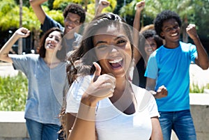 Cheering latin woman with caucasian and african american men