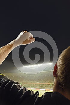 Cheering in stadium at night