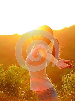 Cheering woman hiker raised arms mountain top