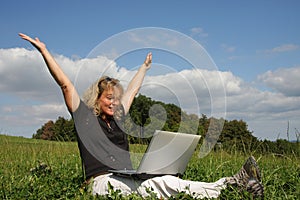 A cheering woman with a laptop