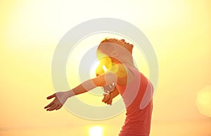 Cheering woman open arms on beach