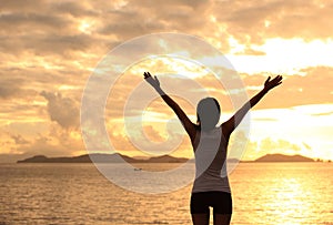 Cheering woman open arms on beach