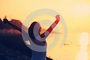 Cheering woman open arms on beach