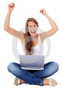 Cheering young woman with laptop