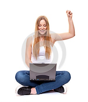 Cheering young woman with laptop