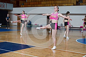 Cheerleader dancer doing pirouette, dancers shows off their moves - pirouette, sport young woman rotates on one leg, girls in