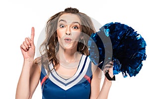 Cheerleader girl in blue uniform holding pompom and showing idea gesture isolated on white