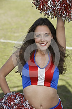 Cheerleader Holding Pompoms With Hand On Hip