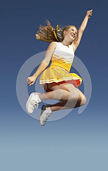 Cheerleader Jumping Midair Against Clear sky
