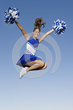 Cheerleader Jumping With Pom-Poms