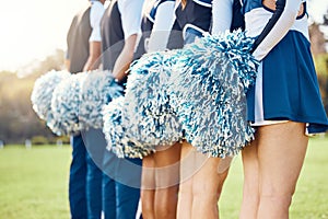 Cheerleader pom poms, backs and students in cheerleading uniform on a outdoor field. Athlete group, college sport