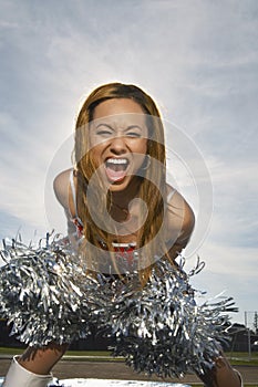 Cheerleader Screaming While Holding Pompom
