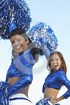 Cheerleaders Cheering In Blue Uniform