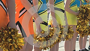 Cheerleaders girls dressed in yellow costumes