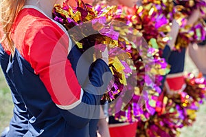 Cheerleaders holding pom-poms in their hands.