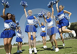 Cheerleaders With Pompoms Cheering On Field