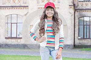 Cheerleading club. Cute child wear cap or snapback hat. Little girl wearing baseball cap. Girl long curly hair wear cap