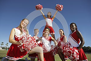 Cheerleading squad in formation on field