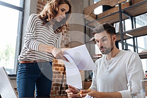 Cheerless beautiful woman holding documents