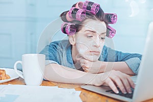 Cheerless depressed woman pressing a button on the keyboard