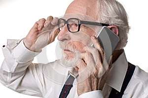 Cheerless old man talking by phone