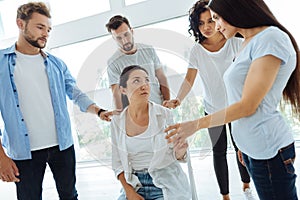 Cheerless pleasant woman looking at her friends