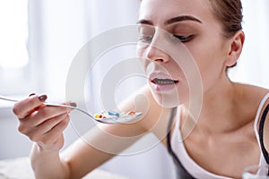 Cheerless unhealthy woman taking medication