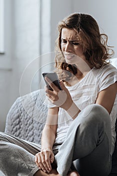 Cheerless upset woman receiving a message