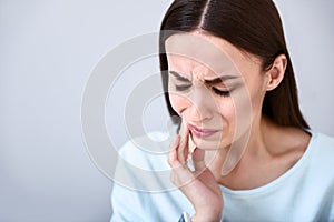 Cheerless woman having toothache