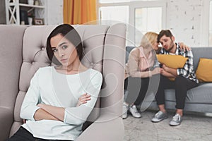 Cheerless young woman sitting in the chair