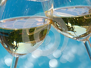 Cheers! clink glasses of white wine photo