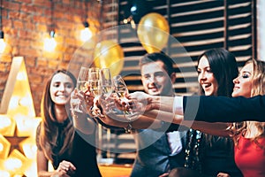 Cheers! Friends with glasses of champagne during party celebration photo