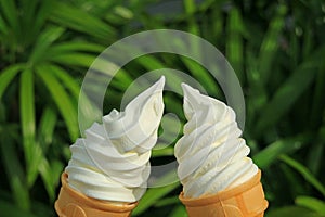 Cheers! with a pair of vanilla soft serve ice cream cones in the sunlight