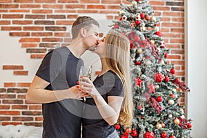 Cheers! Two people holding glasses of shampagne on Christmas. Couple celebrate New Year together