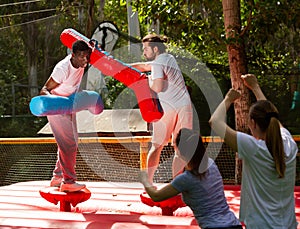 Cheery men having fun on gladiator fight arena