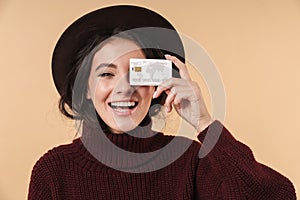 Cheery positive woman holding credit card