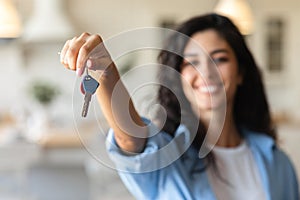 Cheery young woman holding apartment keys, purchasing or renting house, selective focus