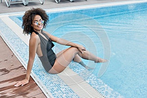 Cheery youthful mulatto lady on summer resort