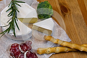 Cheese appetizer selection or Cheese and wine party table. Brie cheese, bread sticks and salami is great appetizer tostart your