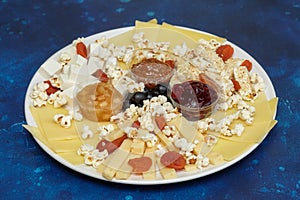 Cheese assorti with sauces and popcorn photo