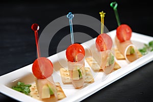 Cheese avocado ham pincho on a dining table