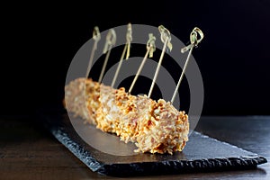 Cheese balls in breading, with natural bamboo skewers.