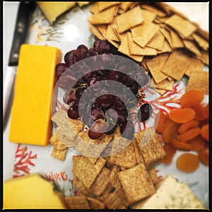 Cheese biscuits and fruit on plate