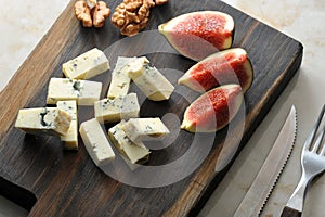 Cheese with blue mold dorblu, a few slices of figs and walnuts