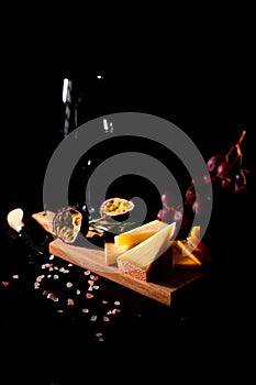 Cheese board on black background. Italian food.