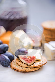 Cheese board with grapes,wine,fig and olives