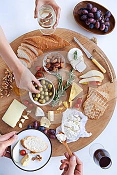 Cheese board with hands, party snacks