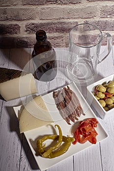 Cheese board next to a beer